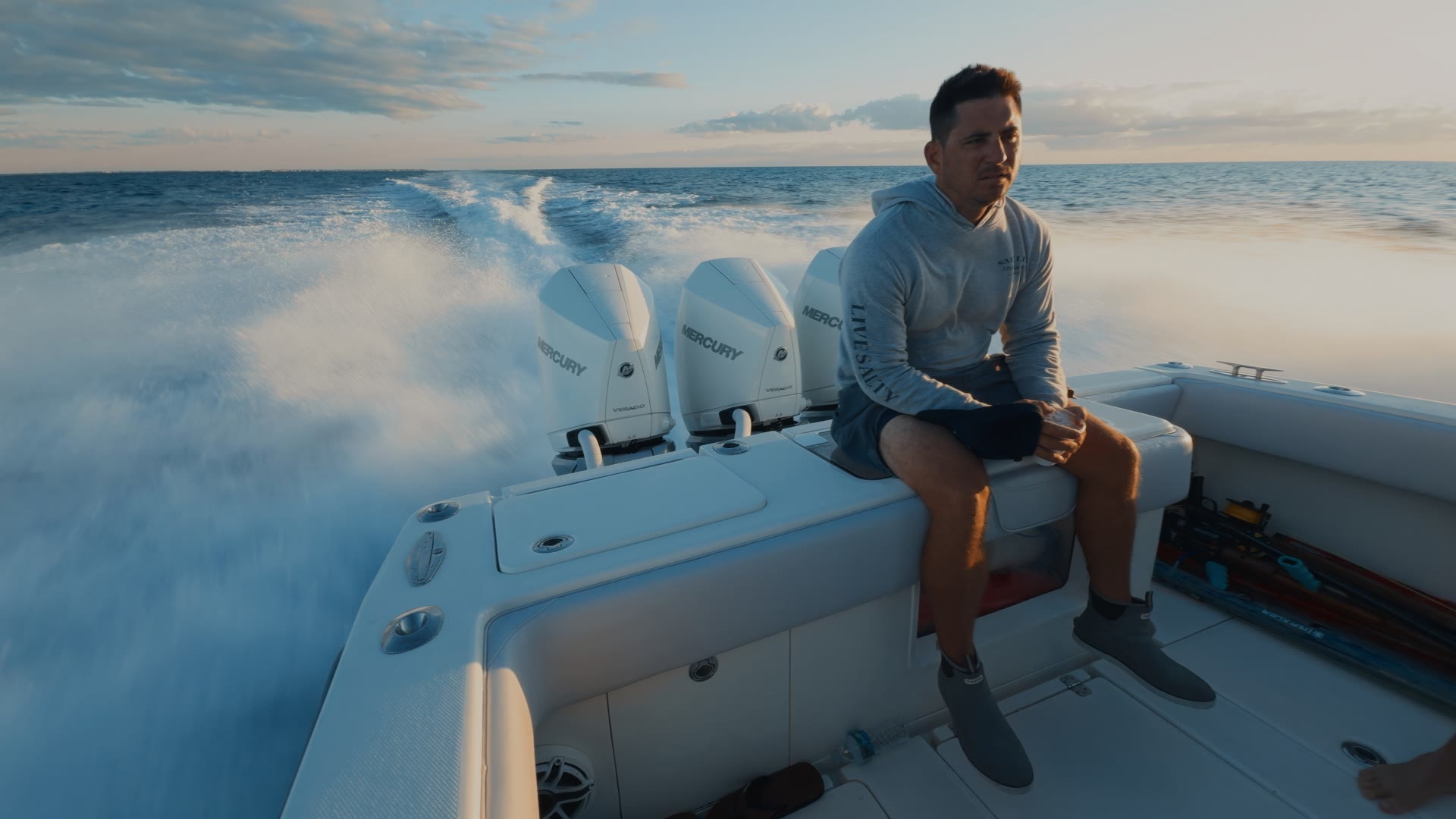 Rider on the stern of a boat at sunrise, graded with AQUA PG