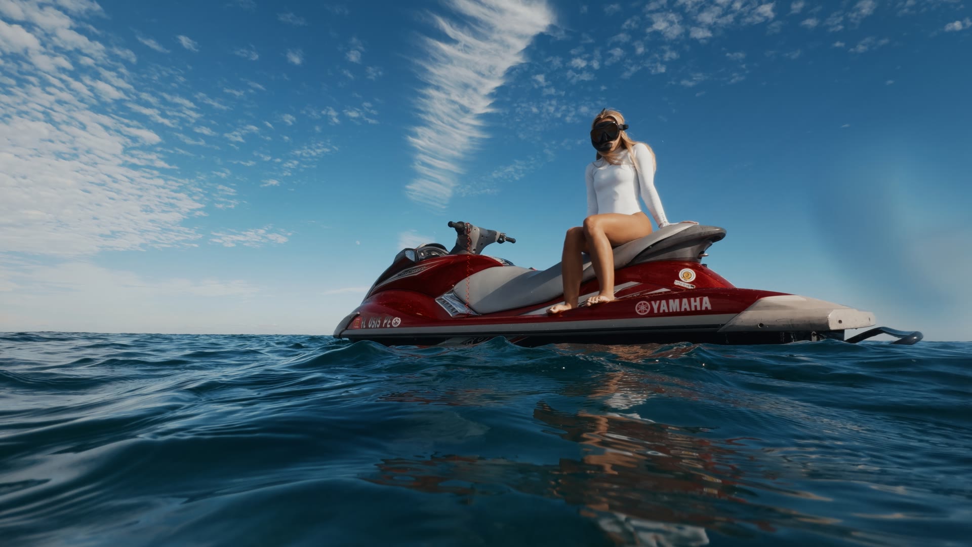 Diver sitting on a jet ski, graded with AQUA PG